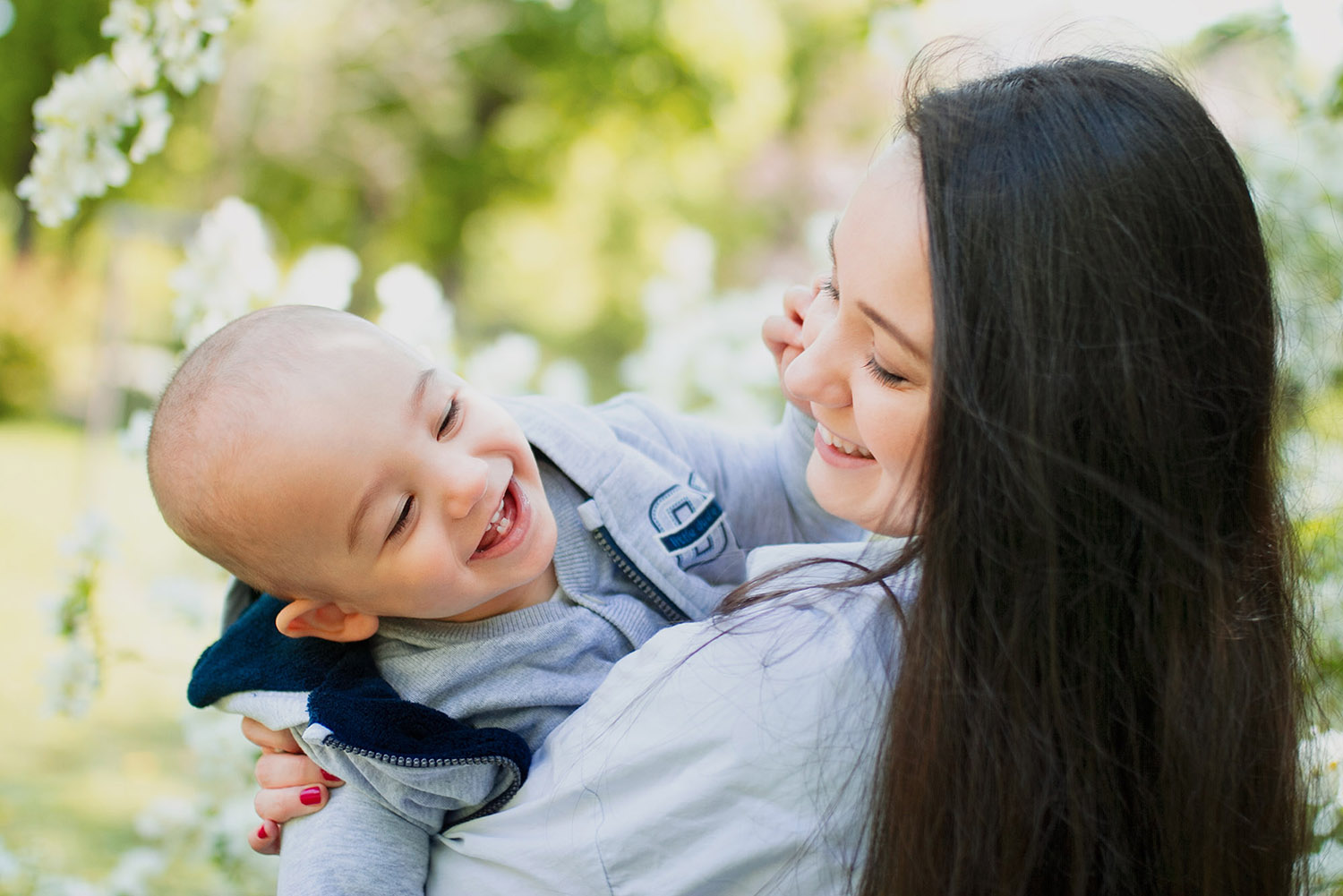 Mother with her small son are smiling