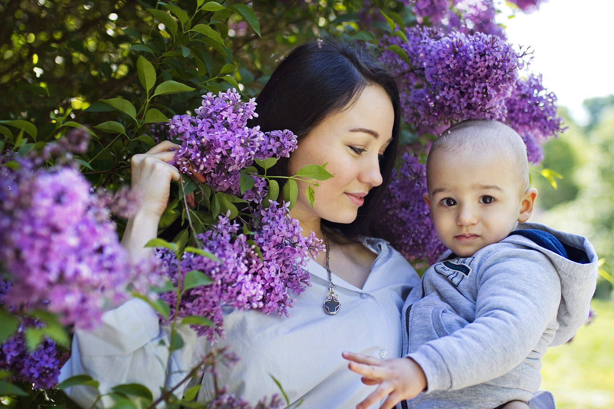 Mother with her small son in flowers