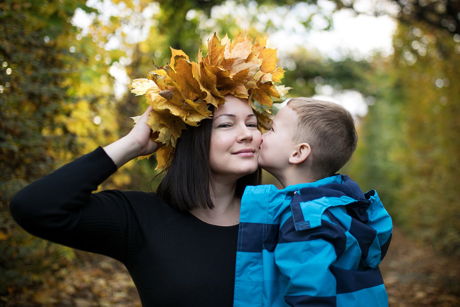 Mother wearing leaf wreath with her son