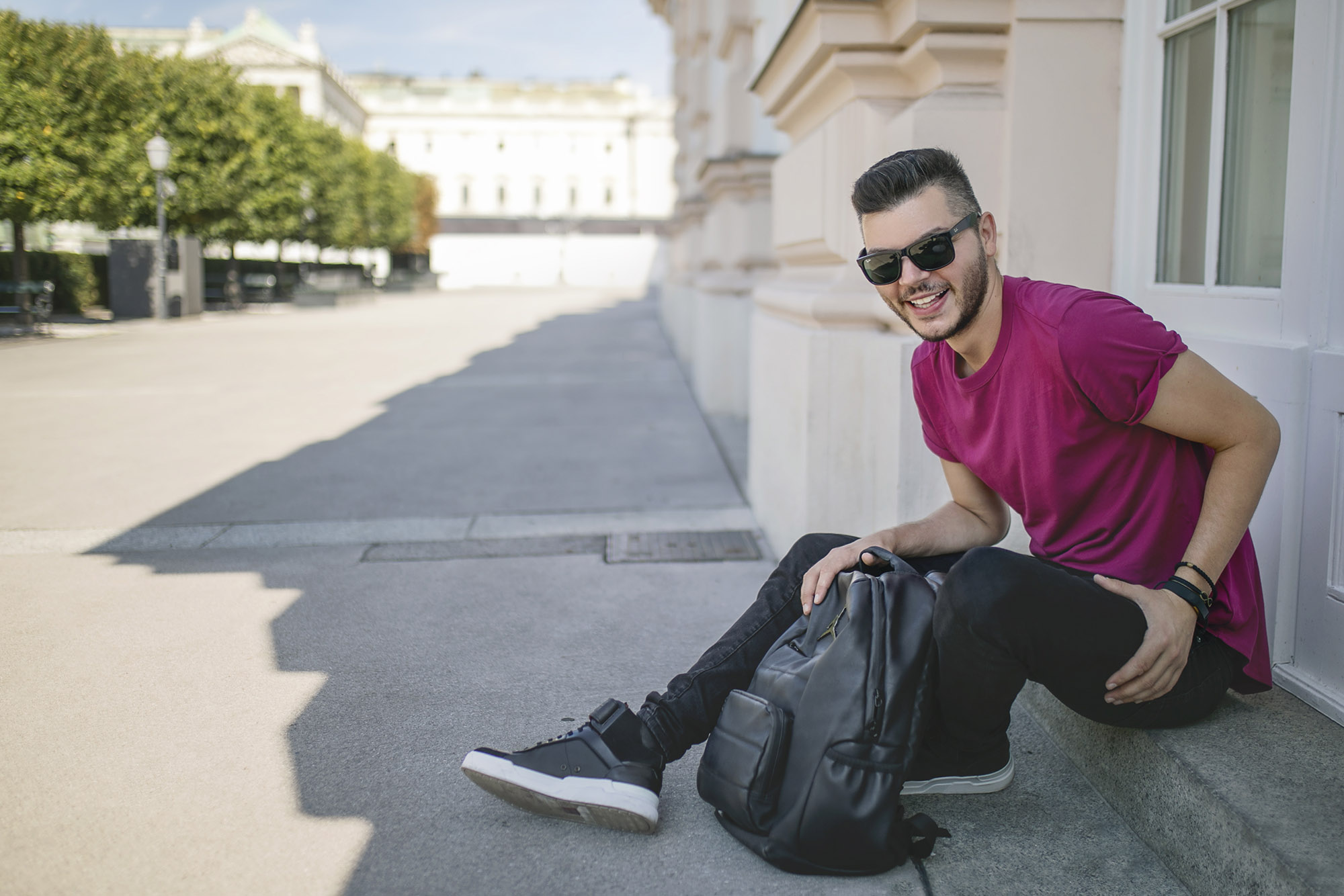 Man in sunglasses sitting on the stairs