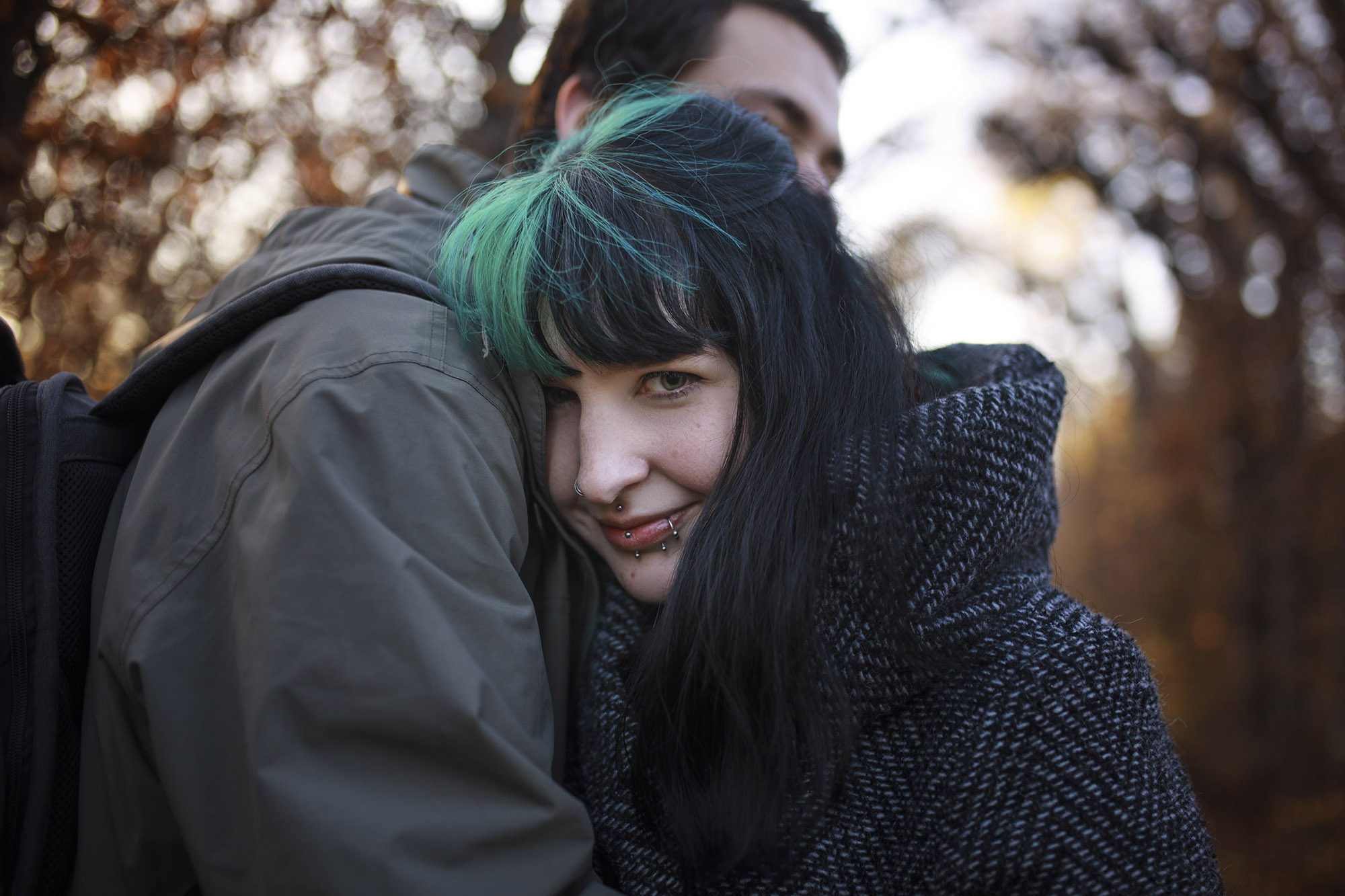 Smiling woman is hugging a man in Schoenbrunn Park