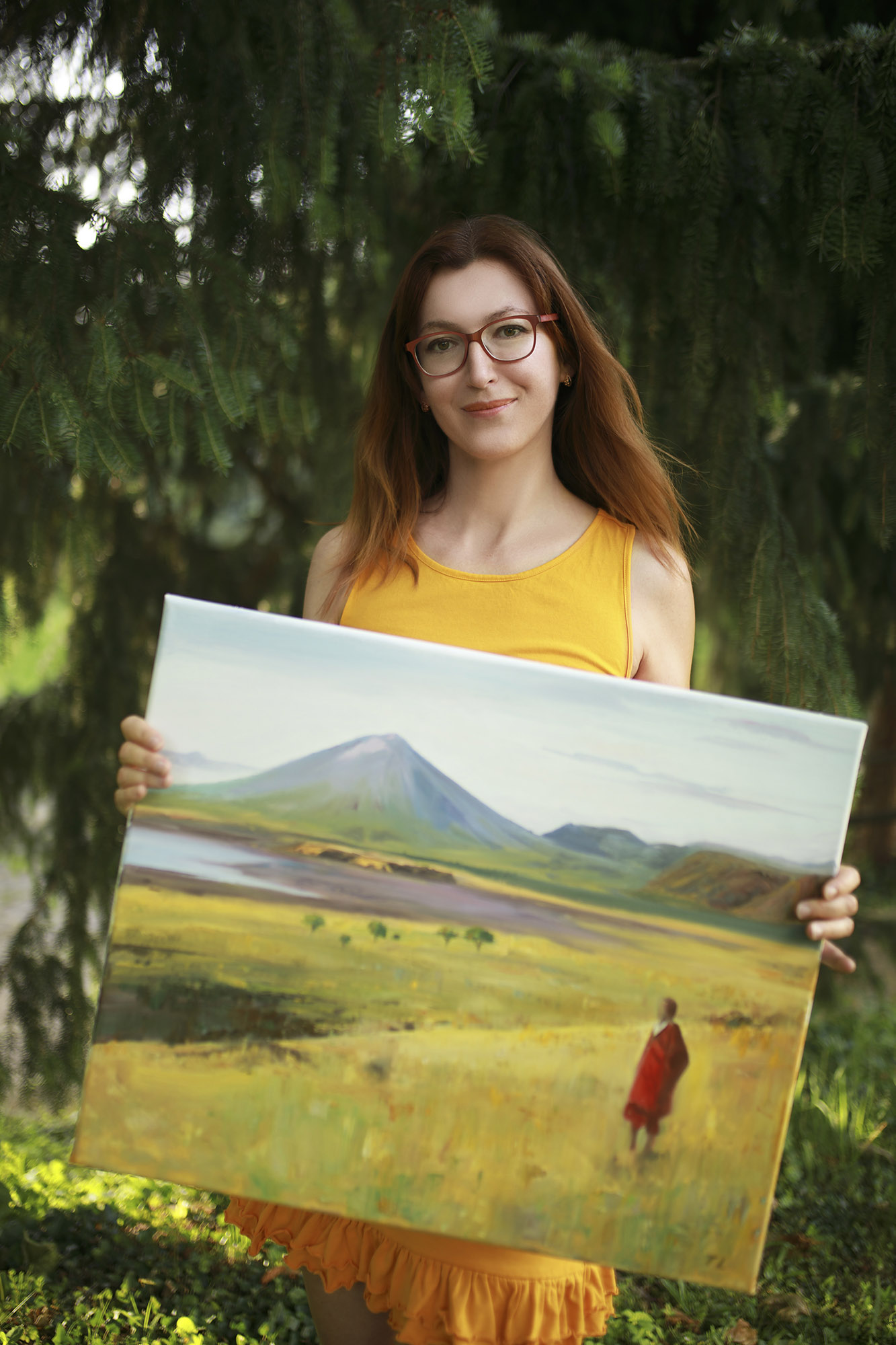Woman holding a painting in forest