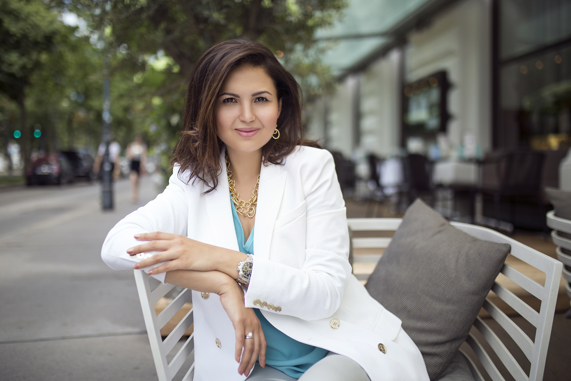 Business Woman in white jacket sitting on a street