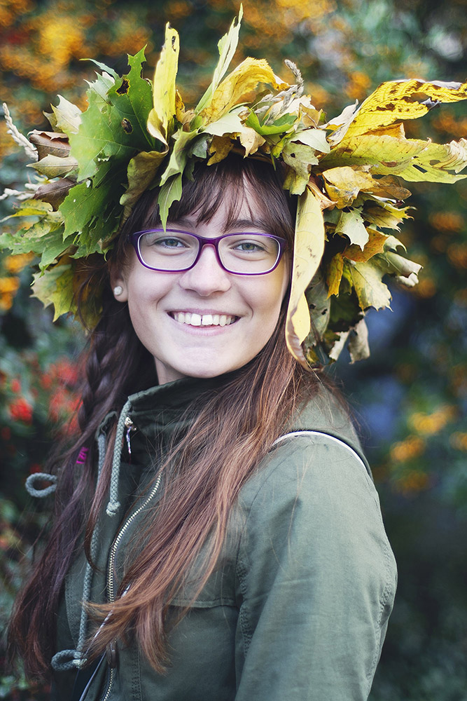 Smiling teenage girl with leaf wreath on her head