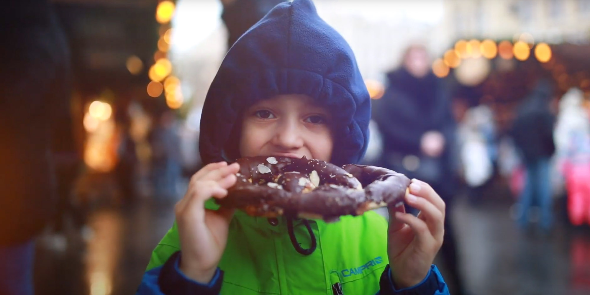 A kid is eating a brecel