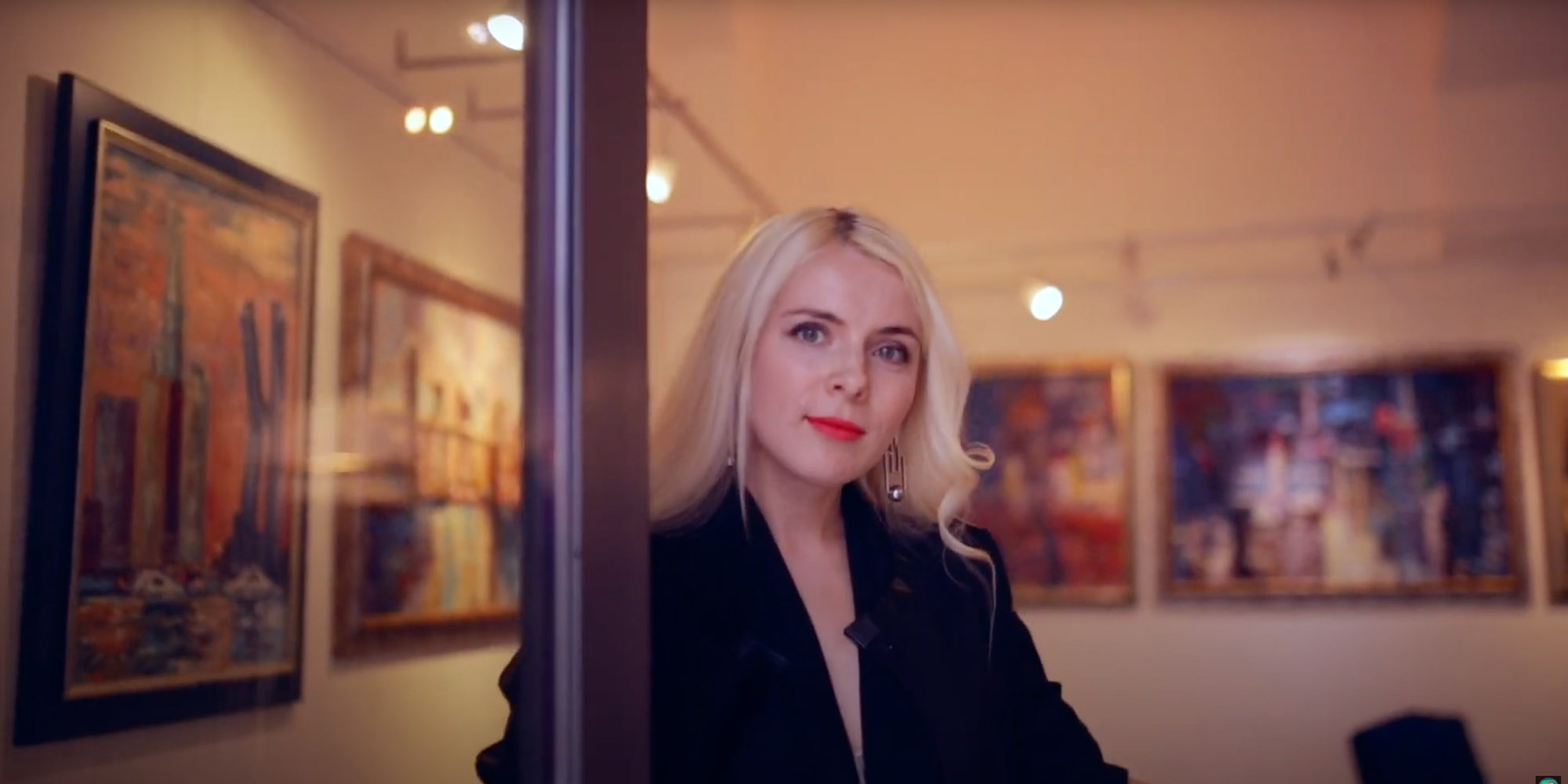 Woman opening a door into an art gallery