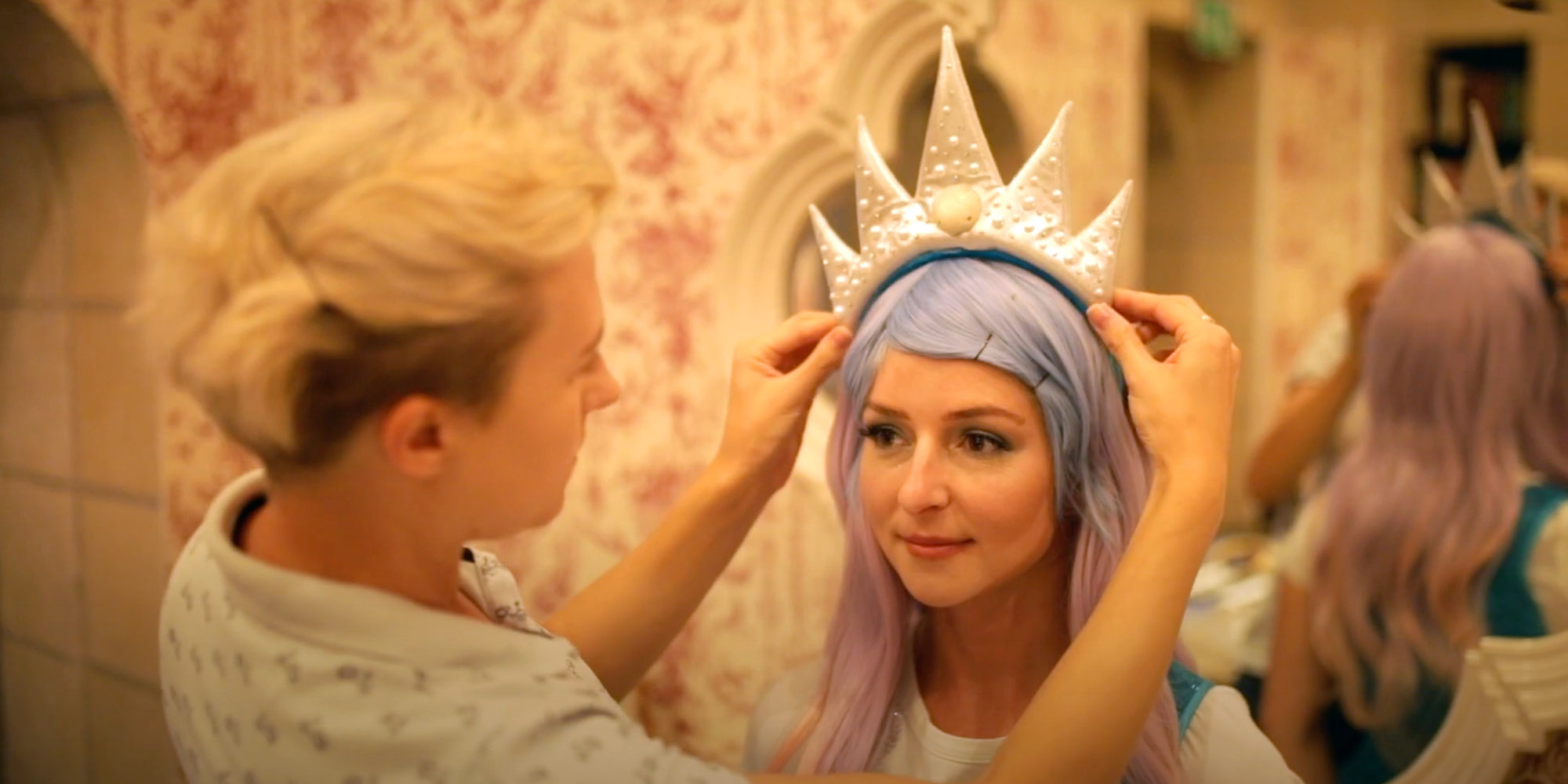 Woman putting a decorated hat on a head